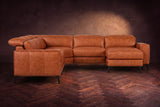 The Esther sectional seen from the front in Tuscan Cognac distressed full leather on a dark herringbone floor, the chaise facing the camera and the footrest closed. Shown in Tuscan Cognac, Right chaise.
