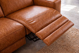 Looking down on the open Esther recliner in Tuscan Cognac: the one-piece footrest out in three padded stages, the black linkage beneath and the seat beside it closed. Shown in Tuscan Cognac, Left chaise.