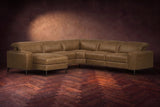 The Esther sectional in Weathered Saddle distressed full leather on a dark herringbone floor, headrests down and footrest closed. Shown in Weathered Saddle, Left chaise.