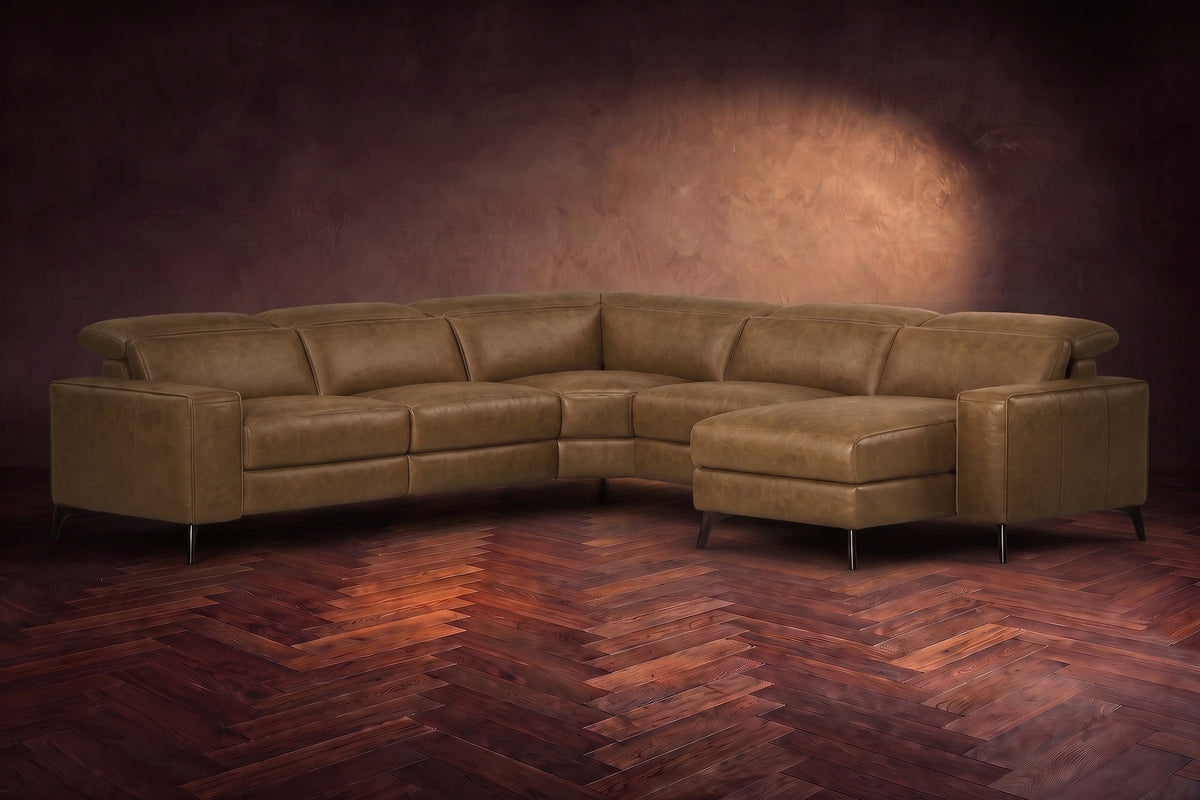 The Esther sectional in Weathered Saddle distressed full leather on a dark herringbone floor, headrests down and footrest closed. Shown in Weathered Saddle, Right chaise.