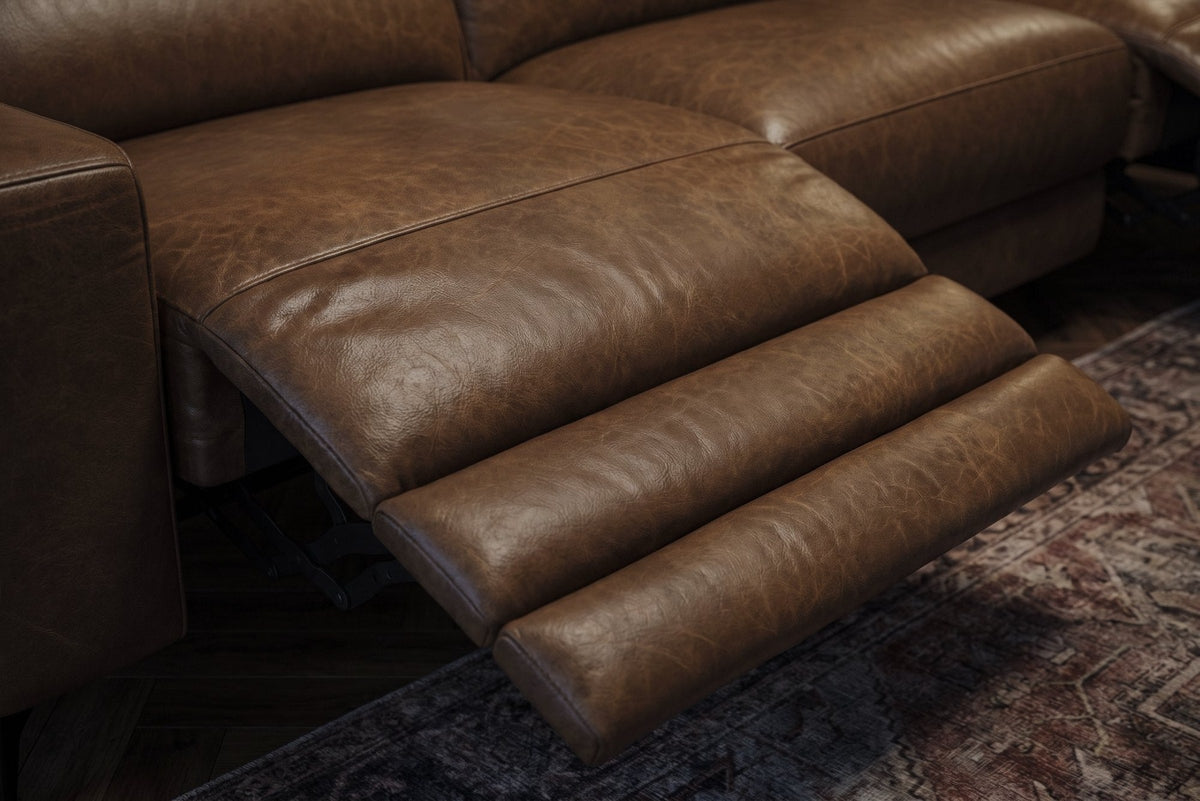 The open Esther recliner in Weathered Saddle, its one-piece footrest out in three padded stages over a patterned rug. Shown in Weathered Saddle, Right chaise.