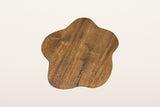The small Exilles top in walnut-stained mango seen from above: a soft cloud outline and swirling grain