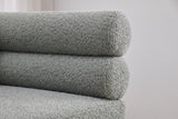 Close-up of the two stacked sage boucle bolsters at one end of the Fabriano bench back