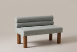 Fabriano armless bench in sage boucle with two stacked bolsters and four round walnut-stained legs
