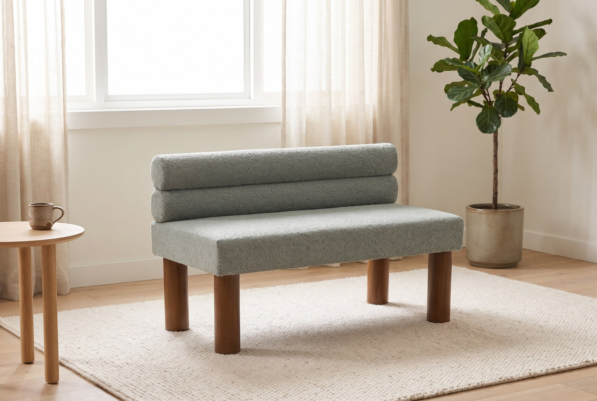 Fabriano bench under a wide window in a bright living room with sheer linen curtains, a fig tree and a pale oak side table