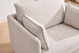 Close-up of a beige chenille throw pillow with its flat flange edge against the slim arm