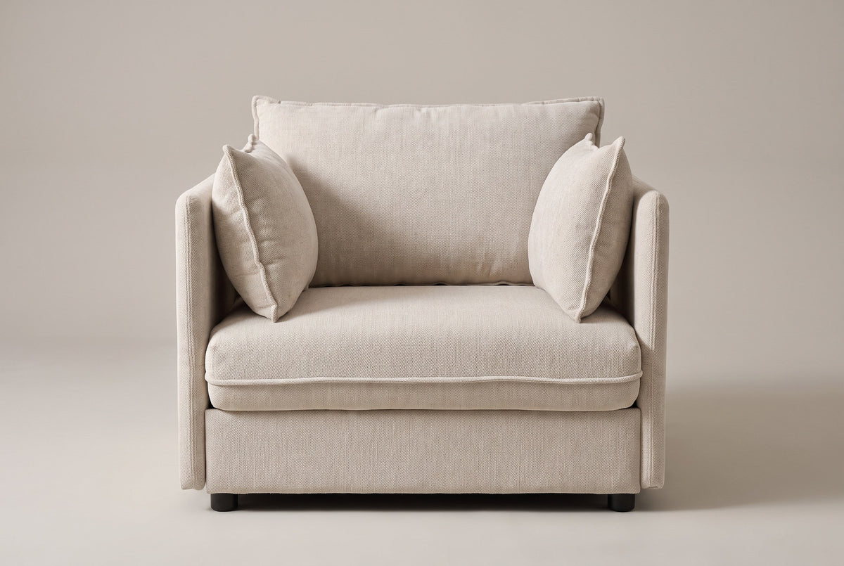 Faenza chair in beige chenille, straight front view: slim flat arms, one back cushion and two throw pillows