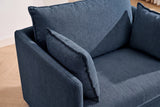 Close-up of the blue chenille chair from above: the back cushion and two throw pillows with flat flange edges