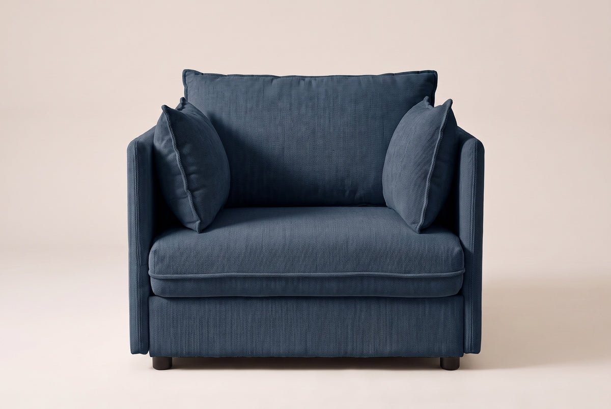 Faenza chair in blue chenille, straight front view: slim flat arms, one back cushion and two throw pillows