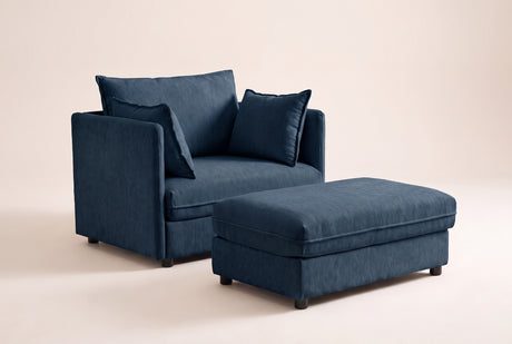 Faenza chair-and-a-half in blue chenille with its storage ottoman, three-quarter view on a warm off-white backdrop