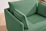 Close-up of the green chenille chair from above: the back cushion and two throw pillows with flat flange edges