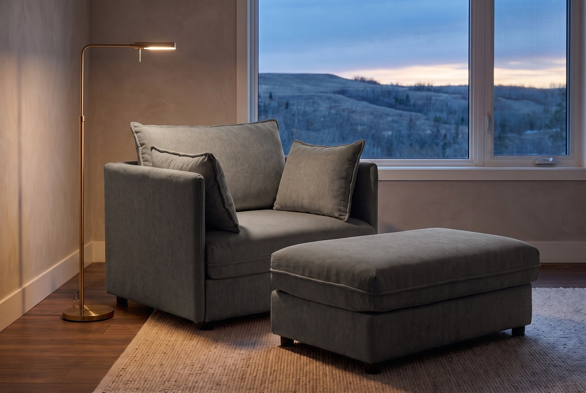 Faenza chair and ottoman in grey chenille in a Calgary family room at dusk