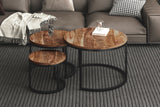 Farrow nesting coffee tables in front of a grey sectional on a striped rug