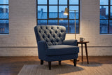 Feltre chair in a Montreal loft in the evening, whitewashed brick and a brass floor lamp lit beside it