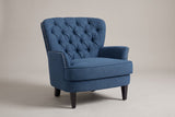 Feltre tufted accent chair in Navy Blue, three-quarter view on a warm grey studio backdrop