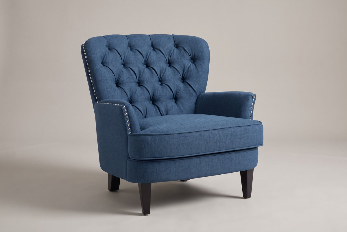 Feltre tufted accent chair in Navy Blue, three-quarter view on a warm grey studio backdrop