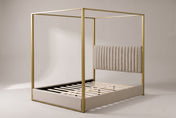 Fermo canopy bed in beige and gold, three-quarter view on a warm grey studio backdrop