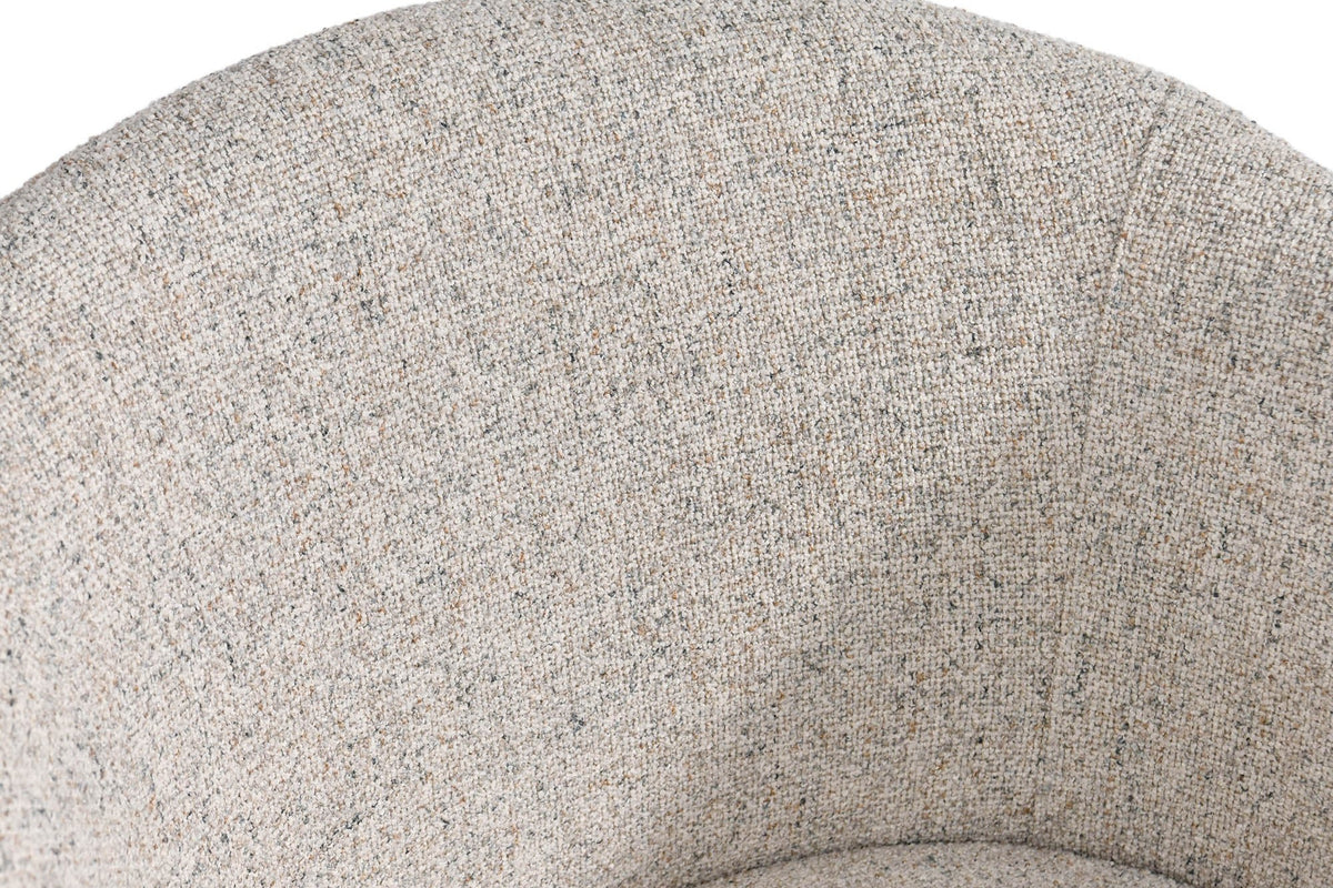 Close-up of the Finley chair's curved back in flecked sand fabric