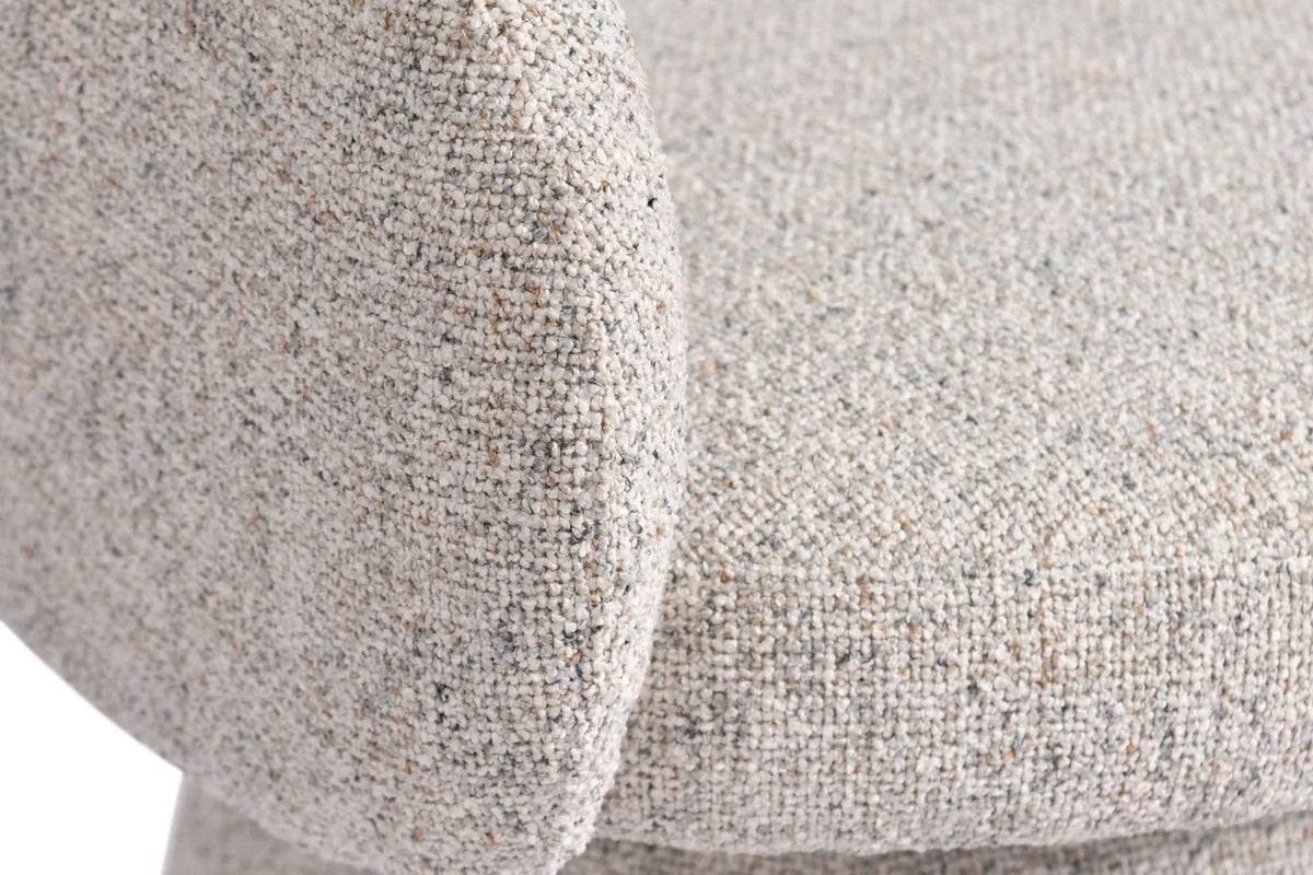 Close-up of the Finley chair's rounded arm and padded seat