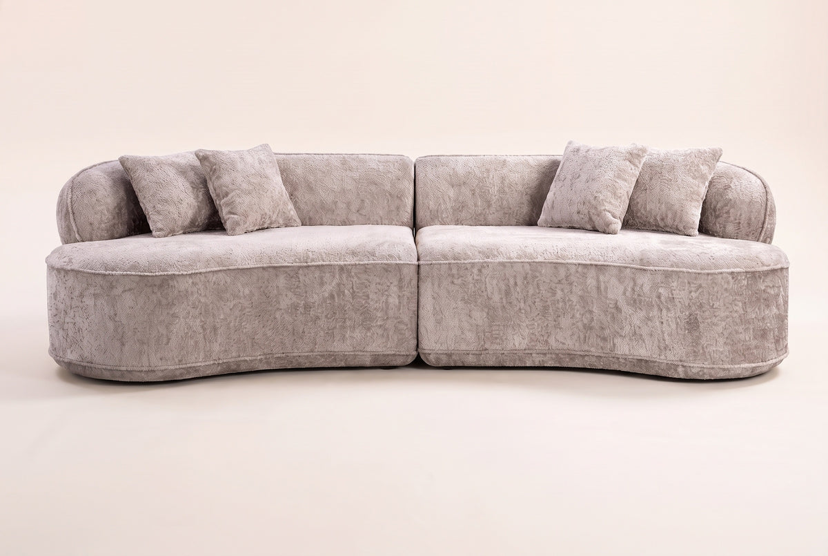 The Fiora curved sofa in Camel seen straight on