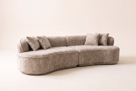The Fiora curved sofa in Camel, front three-quarter view, on an off-white studio background