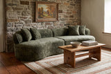 The Fiora sofa in Green in a Catskills stone farmhouse with a braided rug