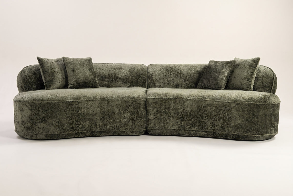 The Fiora curved sofa in Green seen straight on