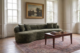 The Fiora sofa in Green in a Georgian drawing room in Wiltshire with panelled shutters and a faded Persian rug