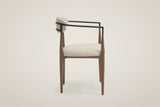 Fiuggi dining chair from the side: the two black arm tubes and the four tapered bronze legs