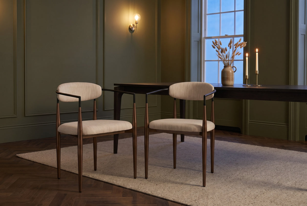Two Fiuggi chairs in an olive-green Toronto dining room in the evening, a dark table and lit candles behind them