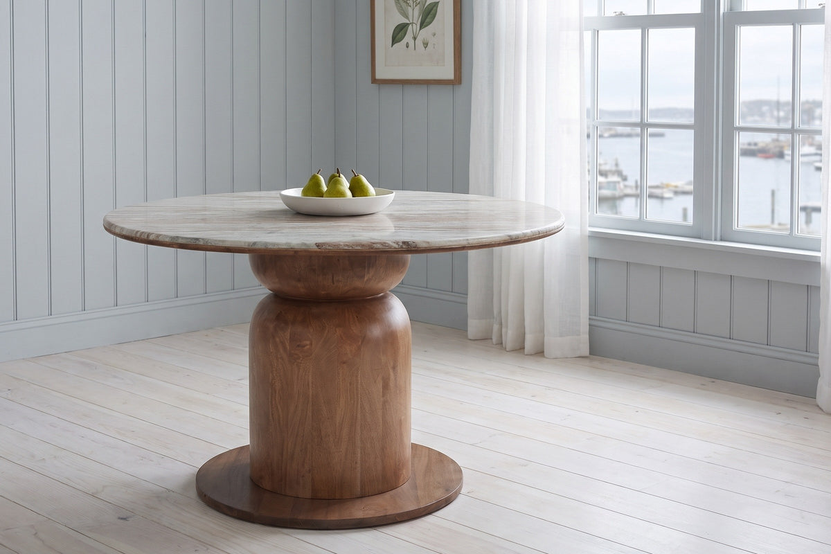 Fiumalbo dining table in a pale blue panelled Halifax dining room with a harbour view, a white bowl of pears on the marble
