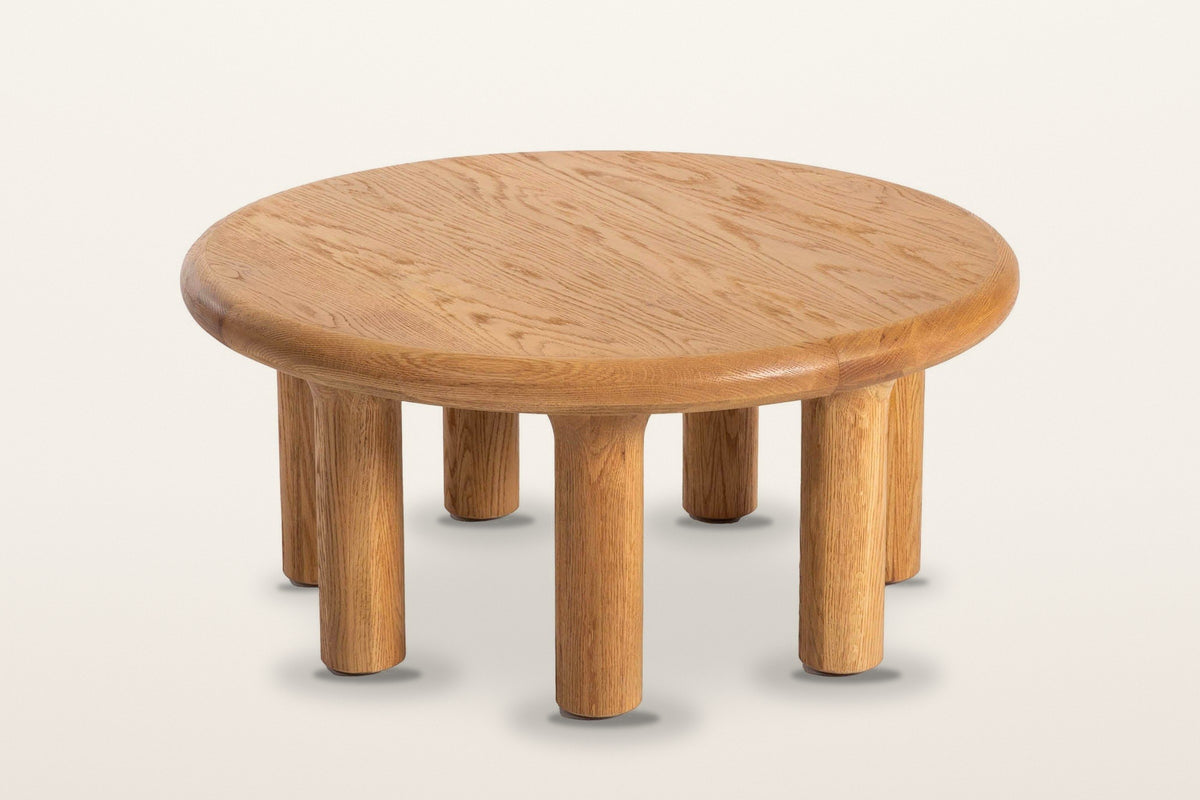 The Fontanellato coffee table in Natural Oak seen from above on a warm white studio backdrop: the round oak top