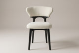 Fosdinovo dining chair, straight front view: wing-shaped cream backrest, open arch, thick cream seat, four black legs