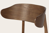 Close-up of a Frascati wood chair: the wrap-around back of moulded plywood with ash veneer