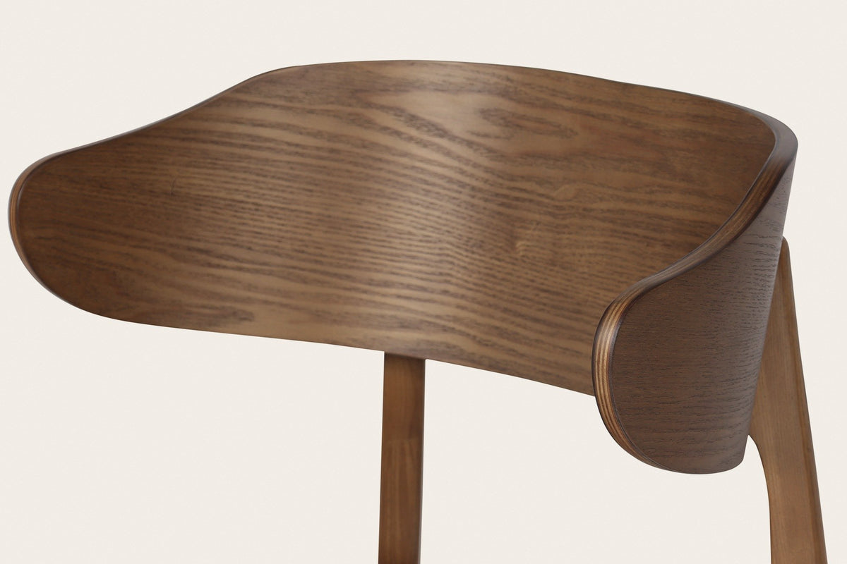 Close-up of a Frascati wood chair: the wrap-around back of moulded plywood with ash veneer