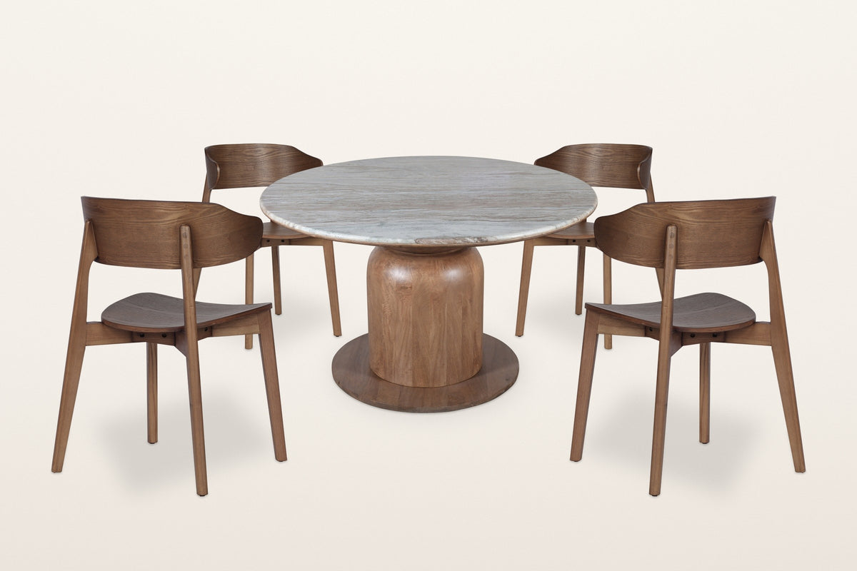 Frascati 5-piece dining set, three-quarter view on a warm white studio backdrop: a round Fantasy Brown marble table on a scul