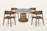 Frascati 5-piece dining set, three-quarter view on a warm white studio backdrop: a round Fantasy Brown marble table on a scul