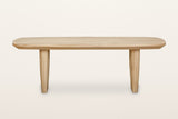 Frontino coffee table in Biscotti Oak, straight front view on a warm white studio backdrop: from the front each slab reads