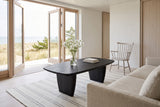 Frontino coffee table in Black seen from above beside an ecru linen sofa in a Skagen dune house, white brick