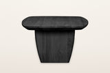 Frontino coffee table in Black from the end on a warm white studio backdrop: the slab leg narrowing toward the floor