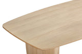 Close-up of a Frontino corner in Biscotti Oak: the rounded corner, the slim bevelled edge and the slab leg below