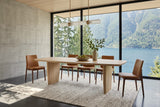 Frontino dining table in Biscotti Oak in a Kootenay Lake house near Nelson, with a board-formed concrete wall