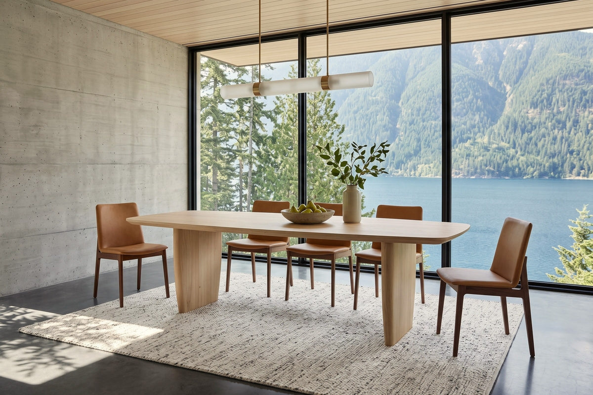 Frontino dining table in Biscotti Oak in a Kootenay Lake house near Nelson, with a board-formed concrete wall