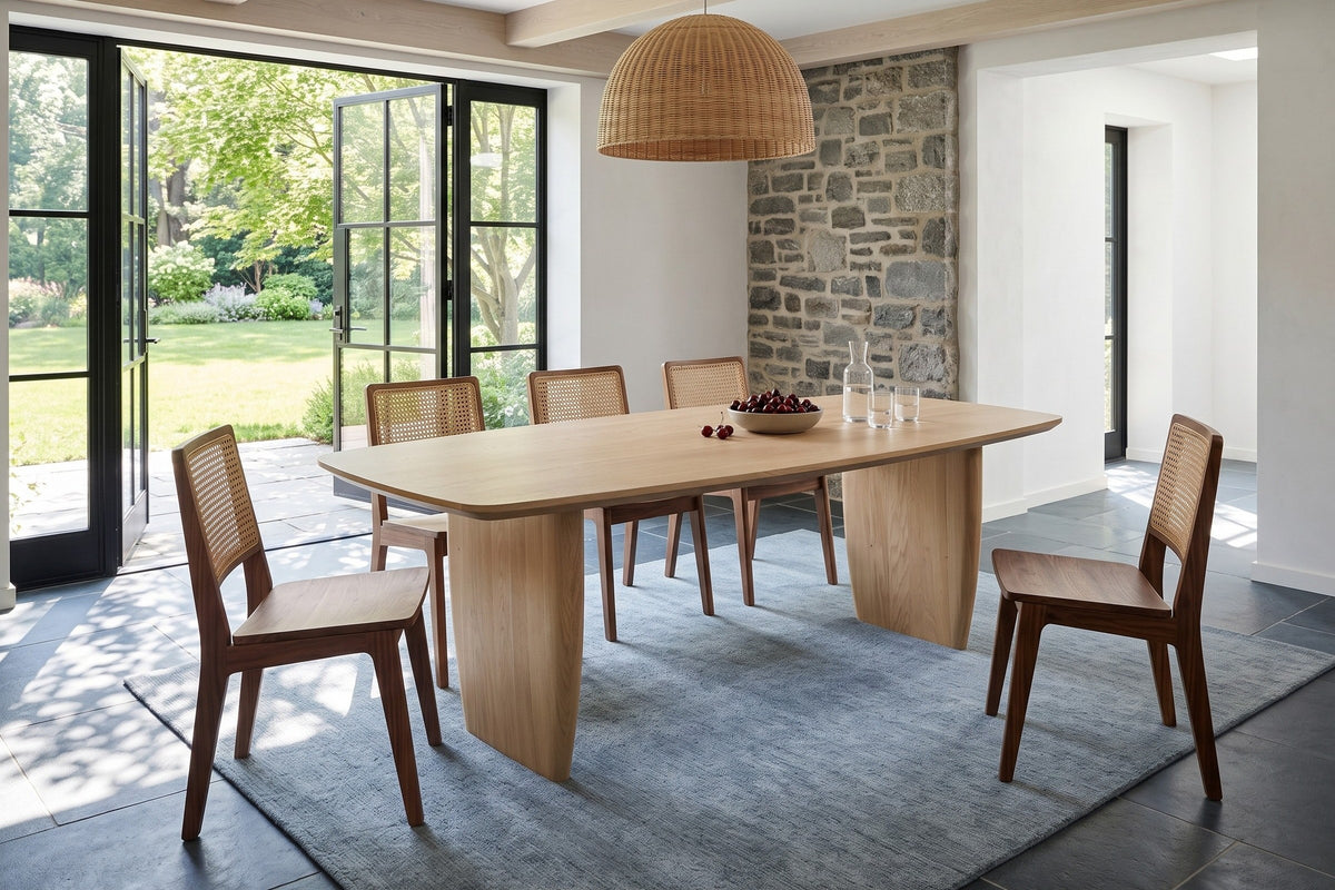 Frontino dining table in Biscotti Oak in a Sillery stone house in Quebec City, with a grey fieldstone wall