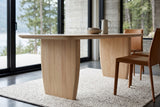 Close view of the Frontino base in Biscotti Oak at seat height: two slab legs with upright grain, narrowing toward the floor