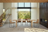 Frontino dining table in Biscotti Oak in a Thornbury orchard house, a tall glass wall with sheers to the apple trees