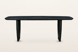 Frontino dining table in Black, straight front view on a warm white studio backdrop
