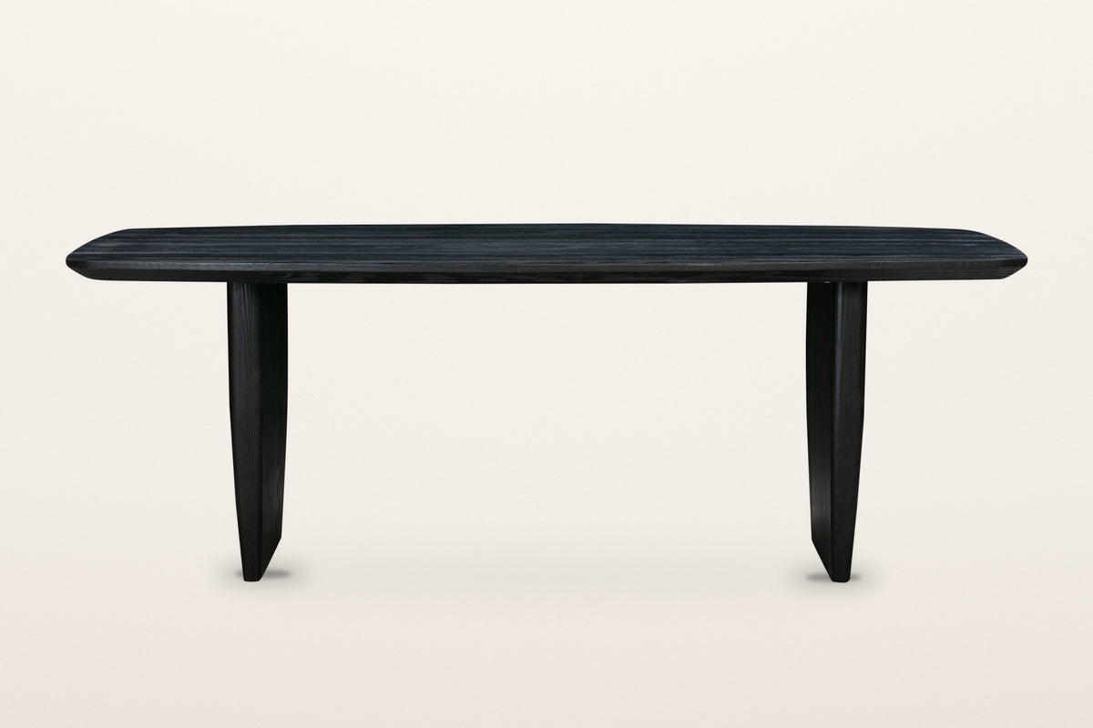 Frontino dining table in Black, straight front view on a warm white studio backdrop