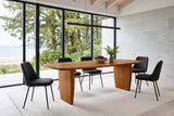 Frontino dining table in Honey Brown in a Haida Gwaii house, with a pale limestone wall, cedar rafters