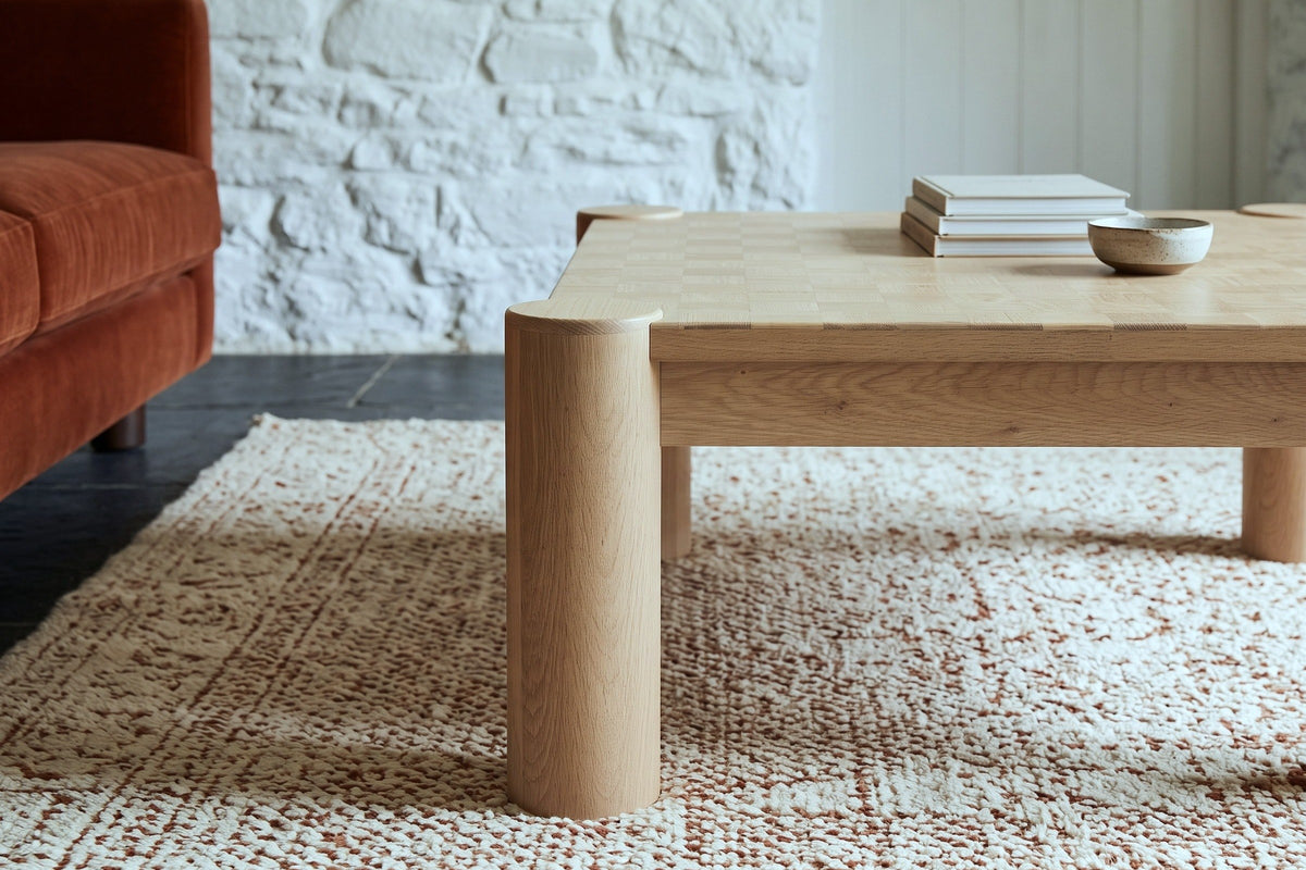 A Furore column leg in Biscotti Oak at the corner, the apron set back behind it